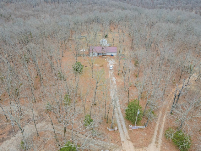 birds eye view of property with a view of trees