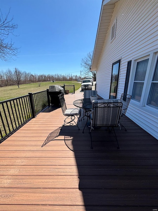 wooden deck with a lawn
