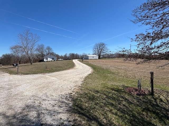view of street featuring driveway and a rural view