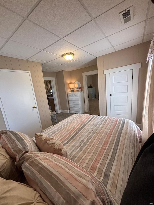 bedroom with visible vents and a paneled ceiling