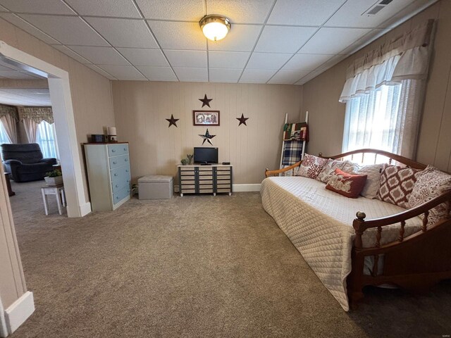 bedroom with carpet floors, multiple windows, and a paneled ceiling