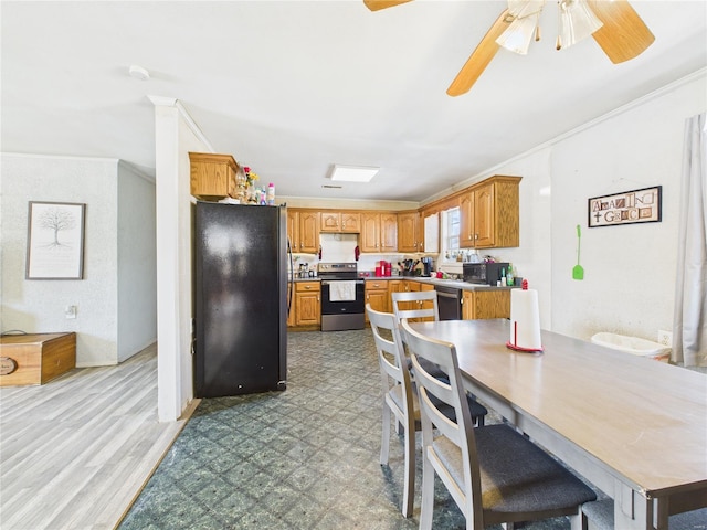 kitchen featuring tile patterned floors, crown molding, brown cabinets, stainless steel appliances, and ceiling fan