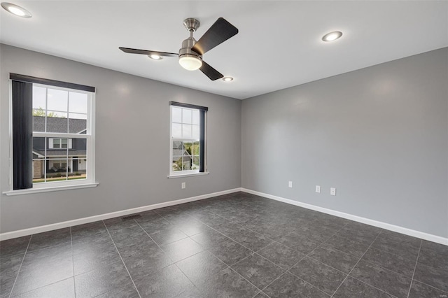 spare room featuring recessed lighting, baseboards, and plenty of natural light