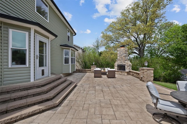 view of patio featuring an outdoor stone fireplace