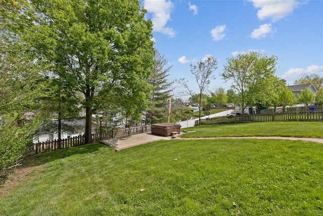 view of yard featuring a fenced backyard, a hot tub, and a patio area
