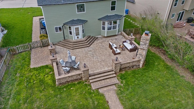 back of house featuring a yard, a fenced backyard, a patio area, and an outdoor hangout area