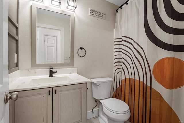 full bathroom featuring toilet, a shower with shower curtain, vanity, and a textured wall