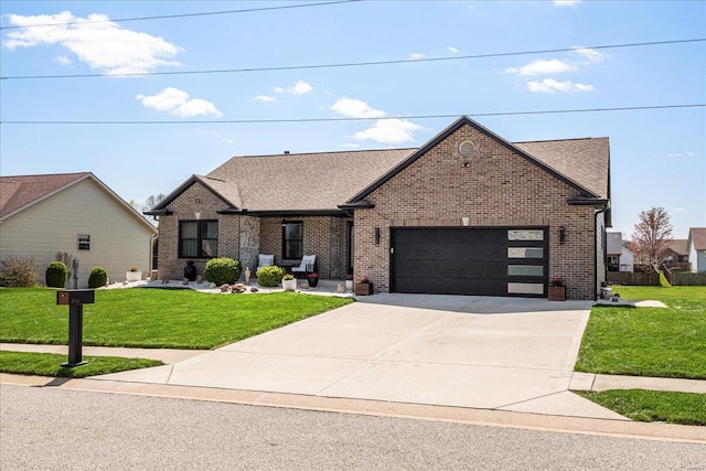 view of front of home with concrete driveway, a garage, a front lawn, and brick siding