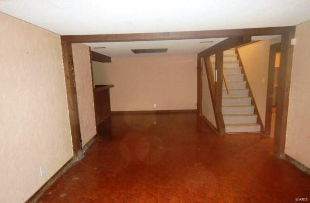 interior space featuring stairs and baseboards