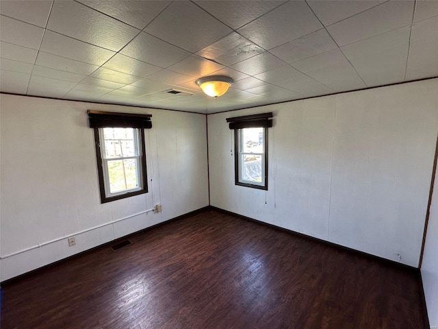 empty room with visible vents and dark wood finished floors