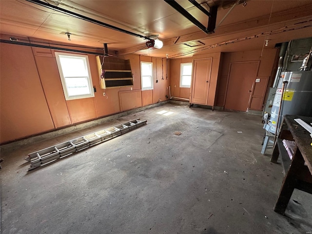 garage featuring gas water heater and a garage door opener