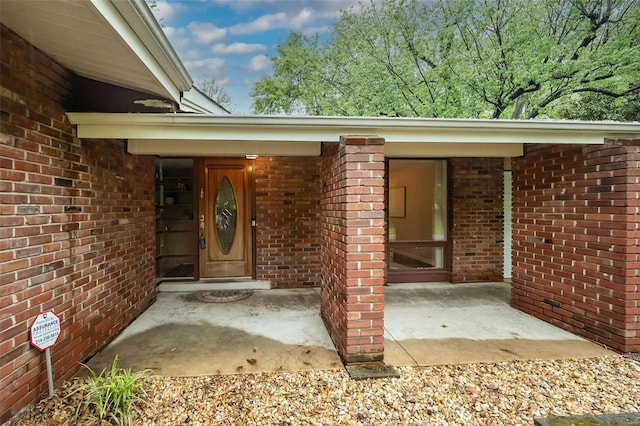 property entrance with brick siding