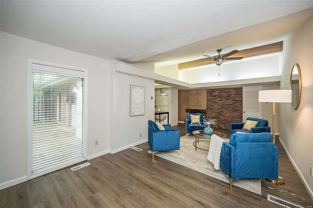 living area featuring visible vents, wood finished floors, baseboards, and ceiling fan