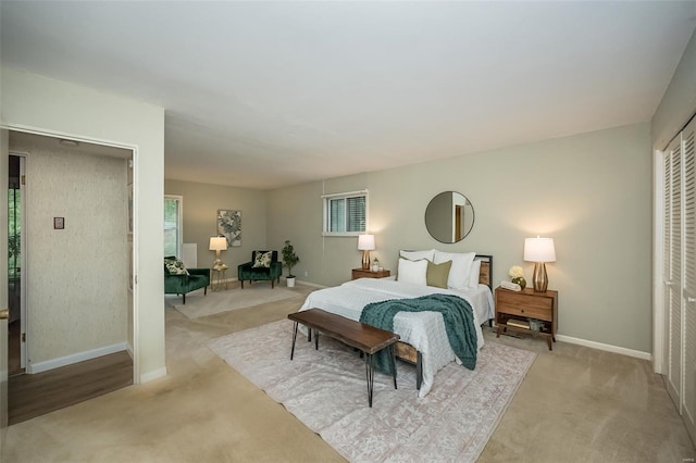 carpeted bedroom featuring baseboards