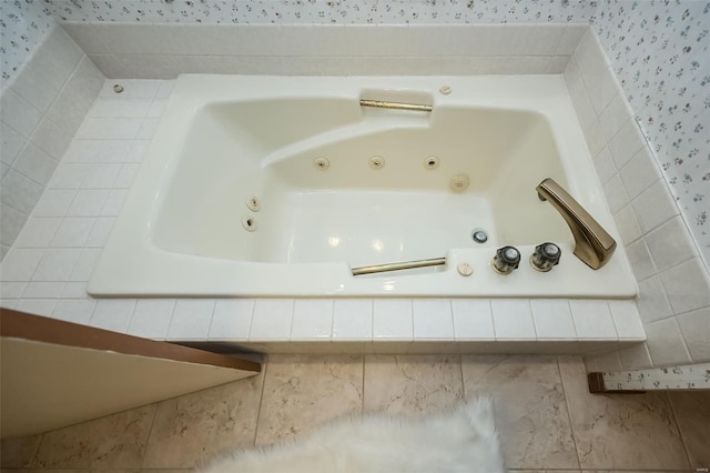 room details with a tub with jets and wallpapered walls