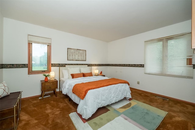 bedroom with carpet flooring, visible vents, and baseboards