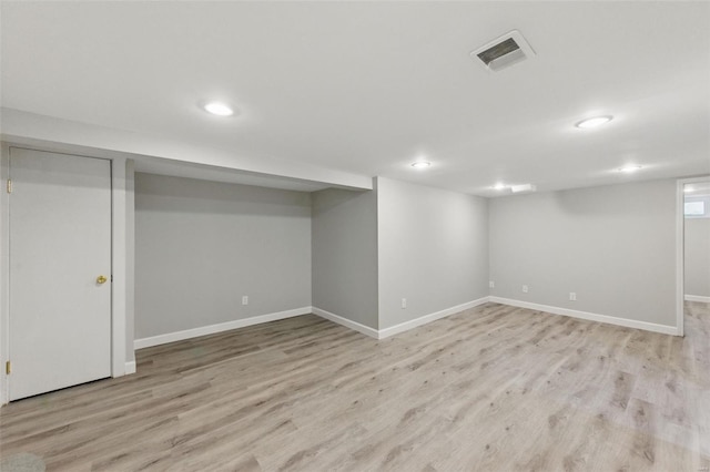 finished basement with recessed lighting, baseboards, visible vents, and light wood-type flooring
