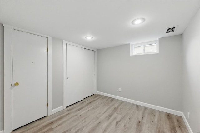 unfurnished bedroom featuring a closet, visible vents, light wood finished floors, and baseboards