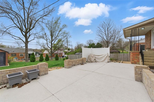 view of patio with a residential view and fence