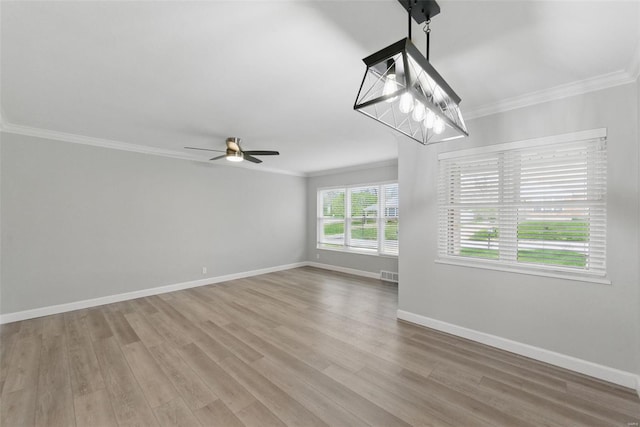 unfurnished living room featuring a ceiling fan, crown molding, light wood-style floors, baseboards, and visible vents