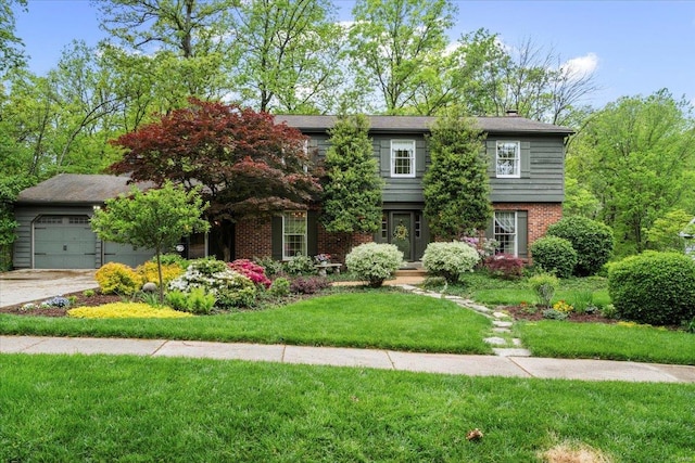 view of front of house with concrete driveway, brick siding, a chimney, and a front lawn