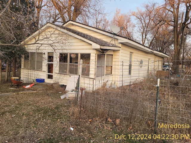 view of property exterior featuring fence