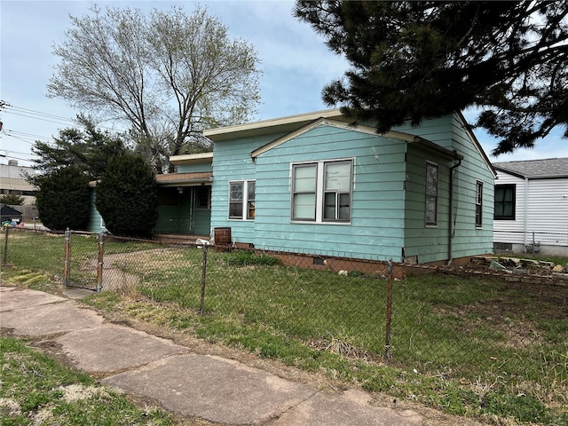 bungalow-style home with a gate, a fenced front yard, and a front lawn