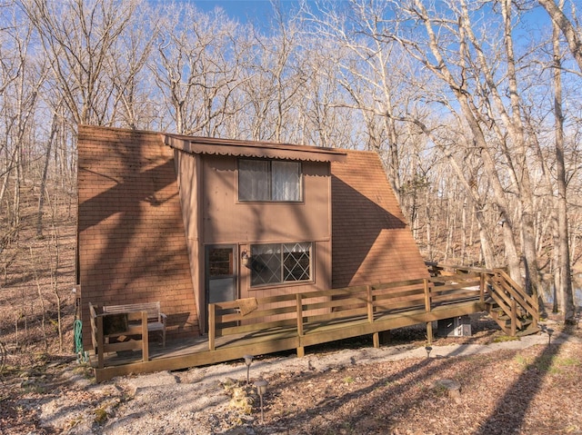rear view of property featuring a deck