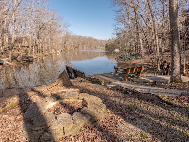 dock area with a fire pit and a water view