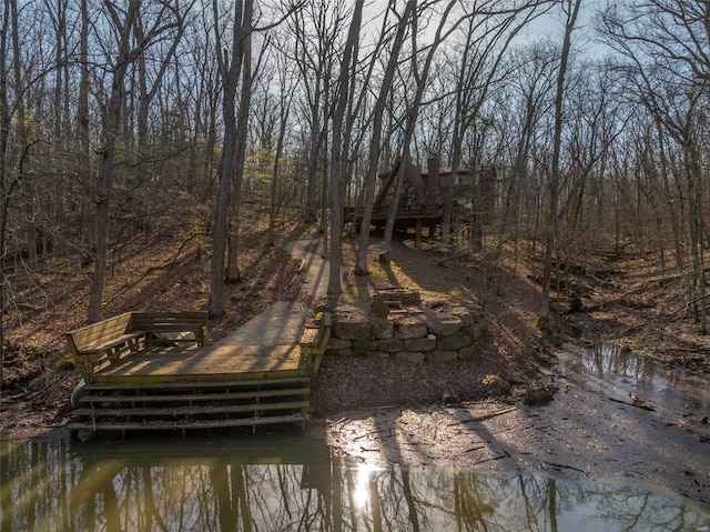 view of dock with a deck with water view