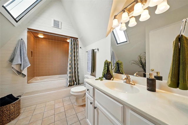 full bathroom featuring vanity, toilet, tile patterned floors, visible vents, and lofted ceiling with skylight