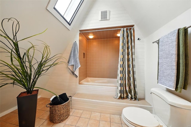full bath with tile patterned flooring, shower / tub combo with curtain, visible vents, and toilet