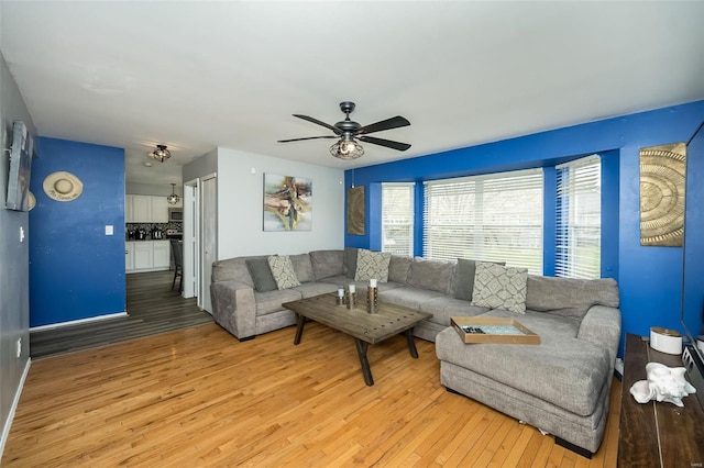 living room with light wood finished floors and ceiling fan