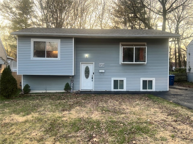 raised ranch with a front yard