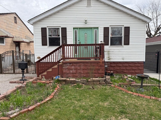 bungalow with a gate, fence, and a front yard