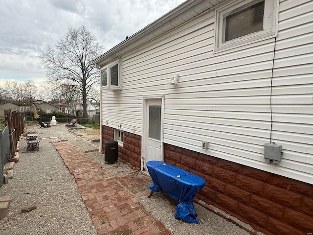 view of side of home featuring fence and a patio area