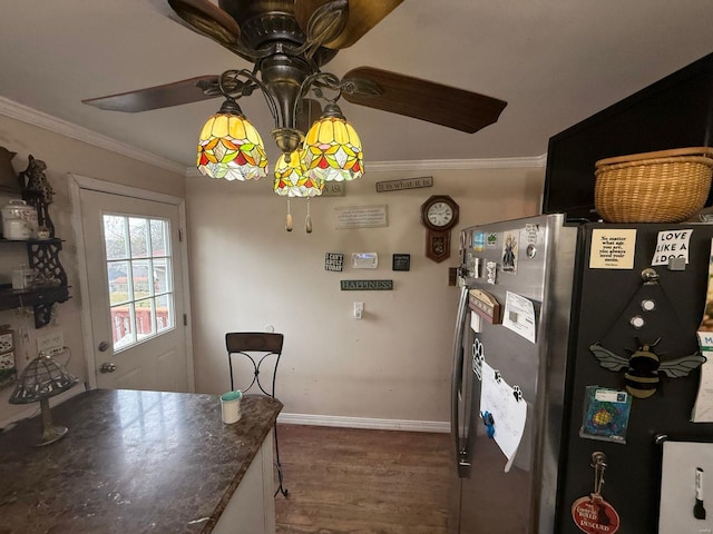 kitchen featuring ornamental molding, baseboards, dark wood-style floors, freestanding refrigerator, and a ceiling fan