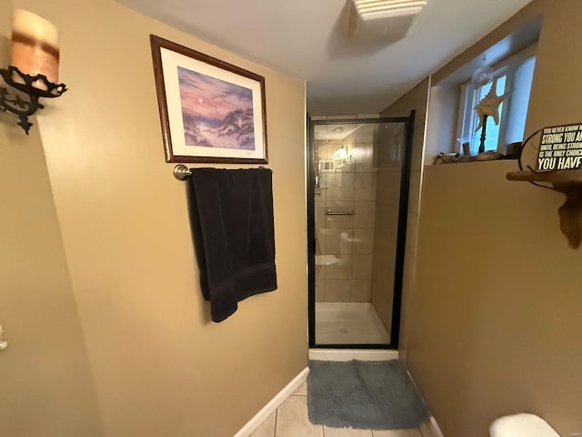 full bathroom with tile patterned floors, a stall shower, and baseboards