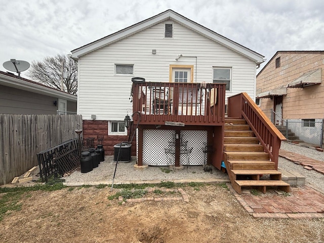 rear view of property featuring cooling unit, stairway, fence, and a wooden deck