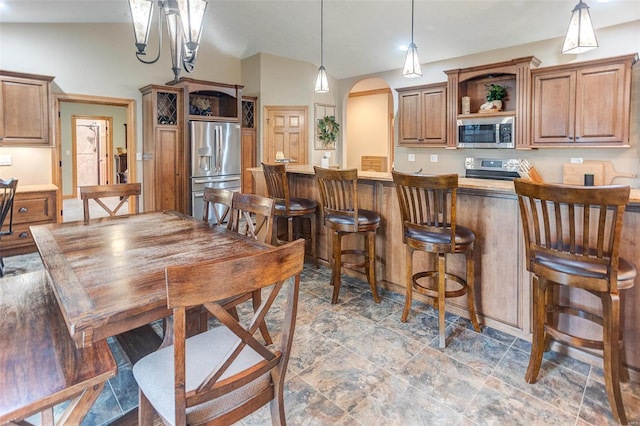 kitchen with brown cabinets, stainless steel appliances, open shelves, a breakfast bar, and arched walkways