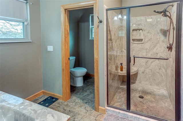 full bathroom featuring tile patterned floors, toilet, a stall shower, and baseboards