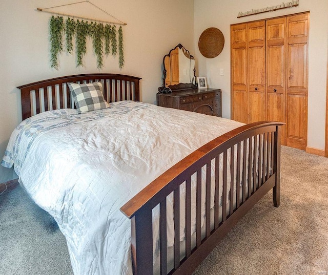 bedroom featuring light colored carpet and a closet