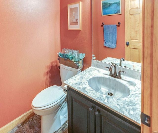 bathroom featuring baseboards, toilet, tile patterned flooring, and vanity