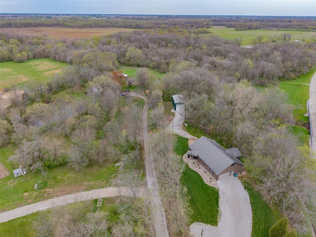 bird's eye view with a wooded view