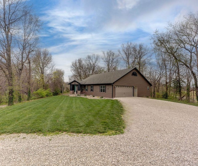 ranch-style home with a front yard, gravel driveway, and a garage