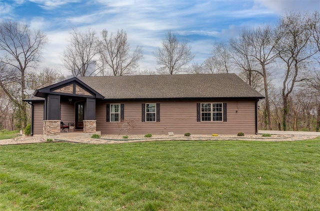 ranch-style home with a front yard and stone siding