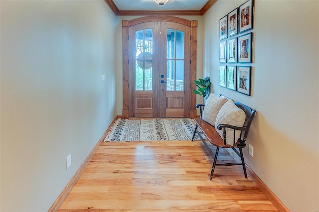 foyer featuring crown molding, french doors, wood finished floors, and baseboards