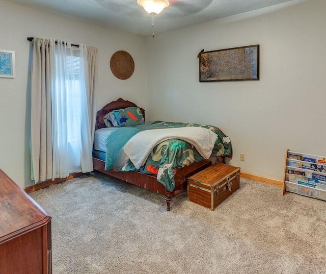 bedroom with baseboards, a ceiling fan, and carpet flooring