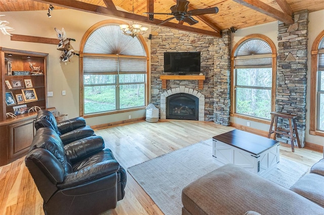 living room with wooden ceiling, vaulted ceiling with beams, a wealth of natural light, and ceiling fan with notable chandelier