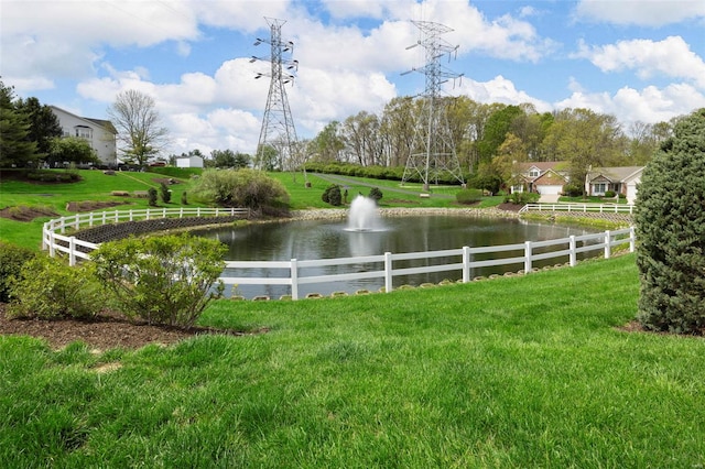 view of yard featuring a water view and fence